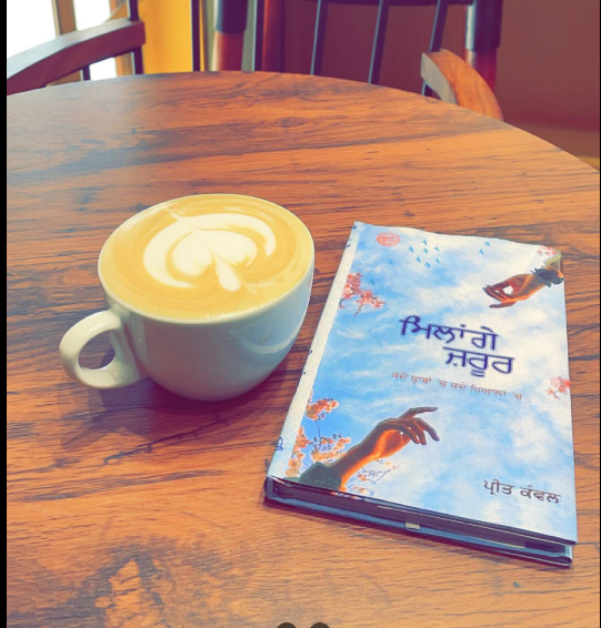 Coffee and a book on wooden table